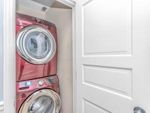 a washing machine sitting next to a door at Penthouse Luxury Oceanfront Condo 3 Bedrooms 3 Bathrooms Ocean Dunes Tower 1 Unit 4155 in Myrtle Beach