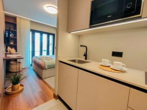 a kitchen with a sink and a counter top at Castle Studios in Leiria