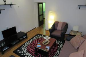 a living room with a couch and a chair at Apartment on Georgiyevskaya 6 in Pskov