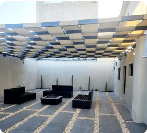 a room with couches in a building with a ceiling at Elegante Loft Pitagoras 1 in San Lorenzo