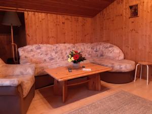 a living room with a couch and a coffee table at Ferienhaus Lerche 3 in Wulfskuhl +1 photo