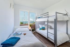 a bedroom with a bunk bed with a ladder at Ferienwohnung Brigantine56 in Olpenitz