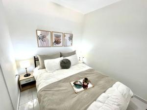 a small bedroom with a bed with a tray on it at Blue dream in Nikiana +26 photos