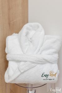 a stack of white towels sitting on a towel rack at Prestige Red z basenem in Pobierowo