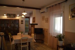 a living room with a table and a television at Dalla Fede in Loreto