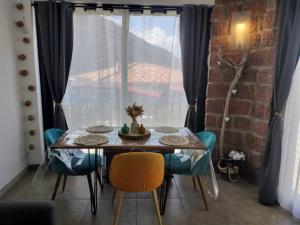 a dining room table and chairs in front of a window at Appartement T2 Porto in Porto Ota