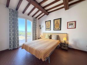 une chambre avec un grand lit et une grande fenêtre dans l'établissement Maison Vue mer- Parking, au Lavandou