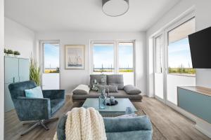 TV a/nebo společenská místnost v ubytování BeachTerraceFour- EG, Meerblick, Terrasse, Kamin, Sauna