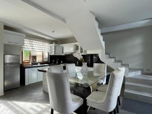 a kitchen with a table and chairs and a staircase at Luxury Villa with Jacuzzi 4 Bedroom 4 Bath in Baños