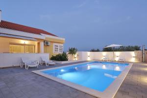 a swimming pool in the backyard of a house at Villa Solaris in Gradina