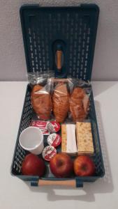 a basket full of food with apples and bread at guesthouse ava roma in Rome