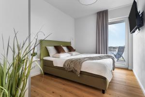 Postel nebo postele na pokoji v ubytování Ocean Harbour- 2 OG, Balkon, Kamin