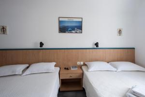 two beds sitting next to each other in a room at SUN -RISE in Perissa