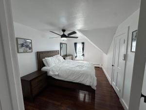a bedroom with a bed and a ceiling fan at The Captains Perch in Stonington