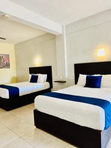 Postel nebo postele na pokoji v ubytování Hotel Jazuli