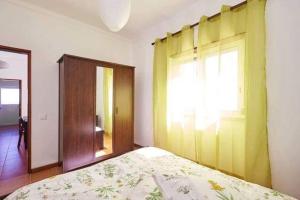 a bedroom with a bed and a window and a door at Ericeira Dream Stay in Ericeira