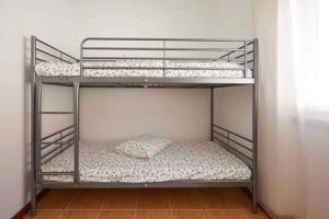 a couple of bunk beds in a room at Ericeira Dream Stay in Ericeira