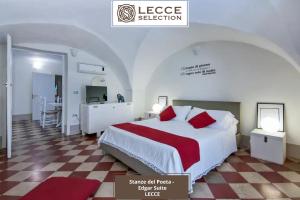 a bedroom with a large bed with a red blanket at Le Stanze del Poeta Apartment - Lecce Selection in Lecce