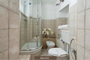 a bathroom with a toilet and a glass shower at Le Stanze del Poeta Apartment - Lecce Selection in Lecce +5 photos