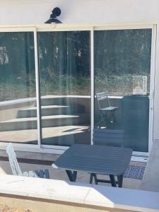 a patio with a table and a chair on a porch at Le Cocon des Lacs in Clairvaux-les-Lacs