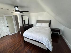 a bedroom with a bed and a ceiling fan at The Captains Perch in Stonington +14 photos