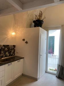 a kitchen with a counter top and a window at Casa Manù in Gallipoli