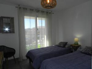 Ένα ή περισσότερα κρεβάτια σε δωμάτιο στο T3 spacieux- Clim- Piscine