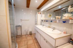 a white bathroom with a sink and a shower at Maison climatisée pour 5 personnes , au clame , jardin arboré proche commerces in Bormes-les-Mimosas +11 photos
