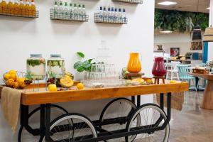 a table with fruit and drinks on top of it at Aparthotel Ona Palamós in Palamós