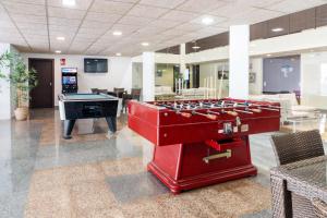 a large room with a pool table and a ping pong ball at Aparthotel Ona Palamós in Palamós