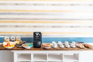 a table with food and an iphone on it at Aparthotel Ona Palamós in Palamós