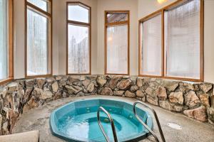 a jacuzzi tub in a room with windows at Hot Tub Access Bright Breckenridge Condo in Breckenridge