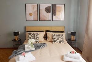a bedroom with a bed with three pictures on the wall at Maria Pia apartment in Borghesiana 