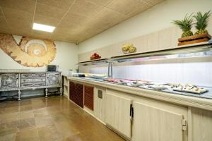 a kitchen with a counter with food on it at Aparthotel Ona Palamós in Palamós