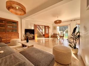 a living room with a couch and a table at Casa Nabia - Coastal Sanctuary in Ericeira