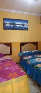 Ένα ή περισσότερα κρεβάτια σε δωμάτιο στο Hotel Peneleuu