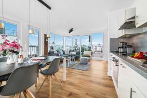 une cuisine et un salon avec une table et des chaises dans l'établissement Schleikubus – Ihr schwimmendes Ferienparadies im OstseeResort Olpenitz, à Olpenitz