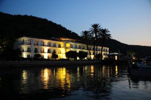 a large white building next to a body of water at Ece Saray Marina Resort in Fethiye