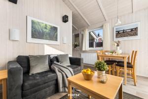 a living room with a couch and a table at Ferienhaus Spitzenblick 2 - Sankt Andreasberg im Harz in Sankt Andreasberg
