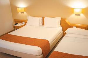 A bed or beds in a room at Best Western Mirage Hotel Fiera