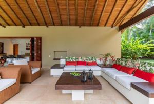 a living room with a couch and a table at Astonishing 5BR House with pool in Anapoima in Anapoima +16 photos