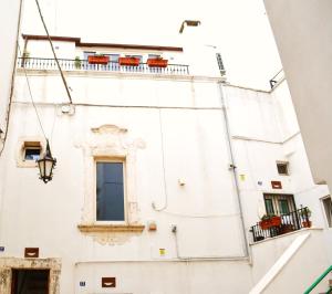 a white building with a window and a balcony at Martine Dimore Storiche di Puglia in Martina Franca