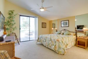 a bedroom with a bed and a sliding glass door at Golf Course Condo with Patio in Cathedral City! in Cathedral City