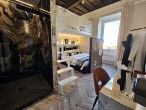 a bedroom with a bed and a large window at Be Your Home - My Attitude in Civitavecchia