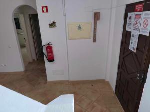 a room with a fire hydrant next to a door at Albufeira INN - Mulatinho V3 in Olhos de Água