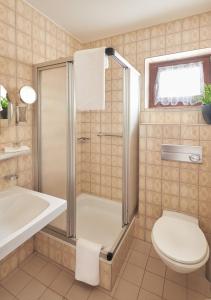 a bathroom with a shower and a toilet and a sink at Muttererhof in Innsbruck