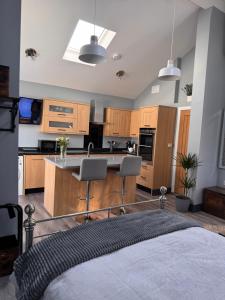 a kitchen with wooden cabinets and a kitchen island at Wend Gardens Studio Carleton Skipton Pet Friendly in Skipton +29 photos