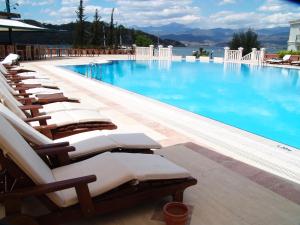 a row of lounge chairs in a swimming pool at Ece Saray Marina Resort in Fethiye
