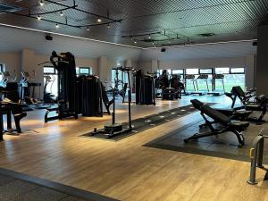 a gym with treadmills and machines in a room at The Wiltshire Hotel, Golf and Leisure Resort in Swindon