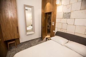 a bedroom with a white bed and a mirror at Luxury Living Jerusalem in Jerusalem